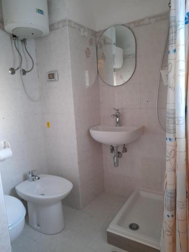 a bathroom with a sink and a toilet and a mirror at Poseidone Ponza in Ponza