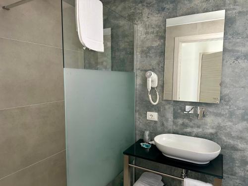 a bathroom with a sink and a mirror at Hotel President in Lido di Jesolo