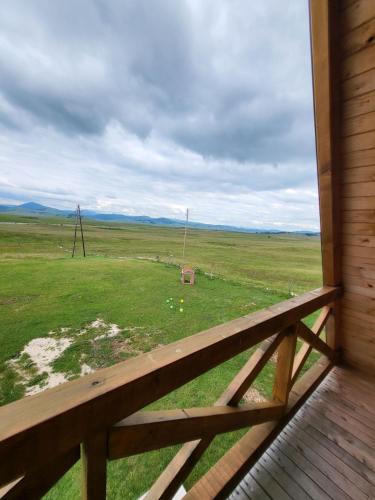 a view of a field from the porch of a house at Monte Diva Zabljak in Žabljak