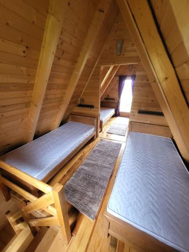 an attic with three beds in a room at Monte Diva Zabljak in Žabljak