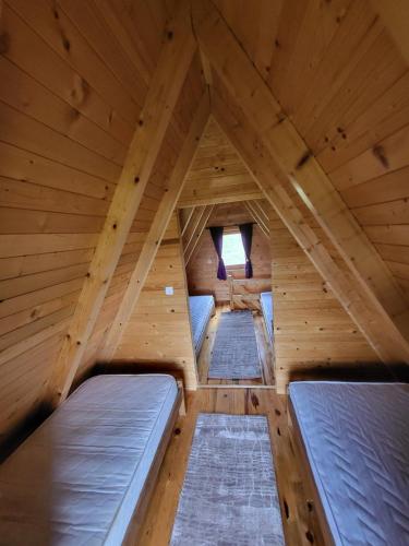 a room with three beds in a wooden cabin at Monte Diva Zabljak in Žabljak