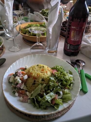 a plate of food with a salad on a table at N&T BDR Hotel in Antananarivo