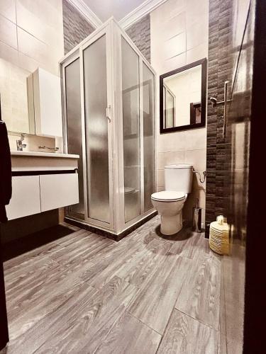 a bathroom with a toilet and a glass shower at Beldi Chic vue Mer - Taghazout in Agadir nʼ Aït Sa