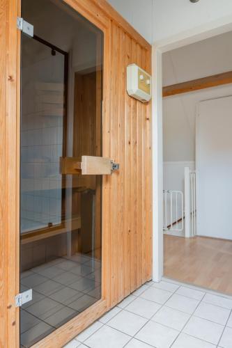 a sliding glass door in a room with a kitchen at Vakantiewoning in villapark de oesterbaai 113 in Wemeldinge