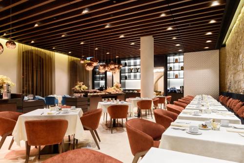 a dining room with white tables and chairs at Áurea Museum by Eurostars Hotel Company in Lisbon