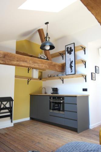a kitchen with wooden beams and a ceiling at La Galerie, Et Pop Et Chic ! in Poitiers