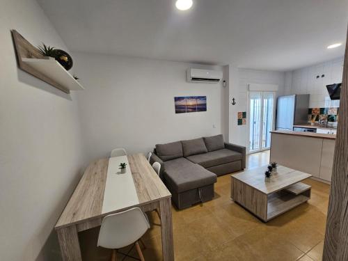 a living room with a couch and a table at apartamentos terraza Chiclana centro ciudad in Chiclana de la Frontera