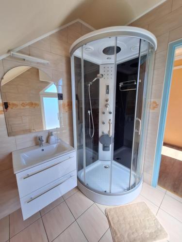 a bathroom with a shower and a sink at Sylvia Apartman in Balatonalmádi