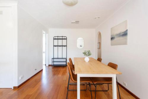 a dining room with a wooden table and chairs at Hillarys Hideaway in Perth