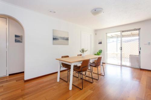 a dining room with a table and chairs at Hillarys Hideaway in Perth
