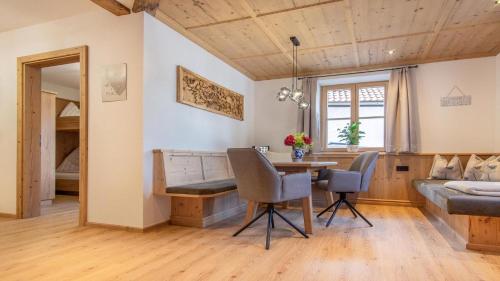 a room with a table and chairs and a bed at Ferienwohnung Zweite Heimat in Mieders