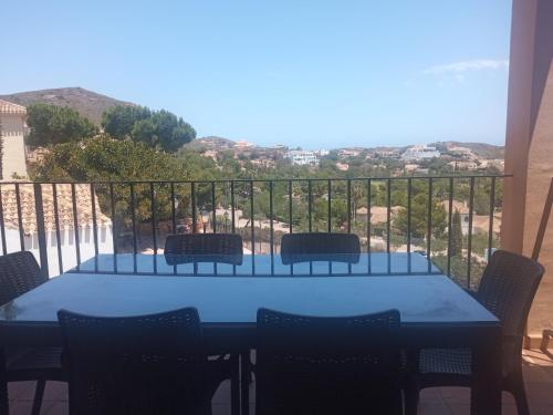 a table and chairs on a balcony with a view at ELIO La Manga Club 5, golf & spa in La Manga del Mar Menor