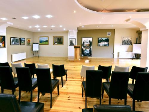 a room with chairs and paintings on the walls at Aurora Resort & Spa in Berovo