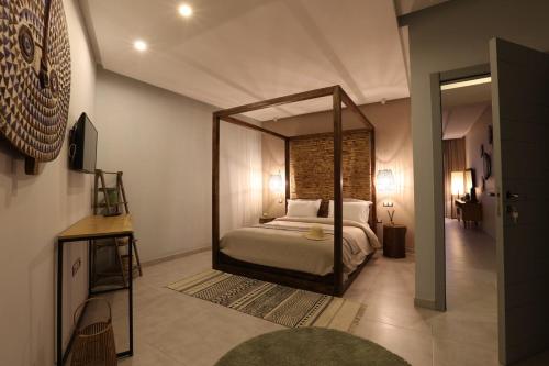 a bedroom with a canopy bed with a mirror at Immi in Agadir