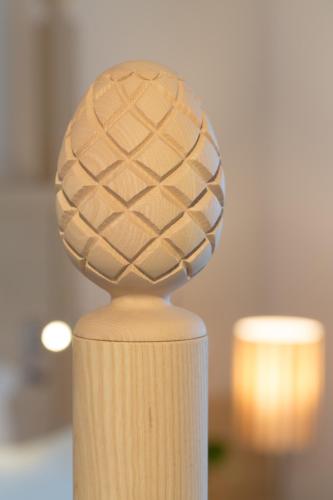 a wooden vase with a ball on top of it at Akoya Hotel & Spa in Saint-Gilles les Bains