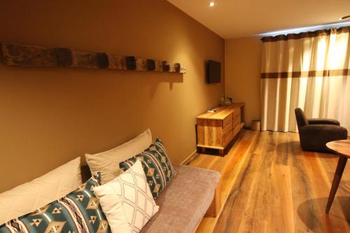 a living room with a couch and a chair at Nosy Manga - Hotel Ivato Airport in Antananarivo