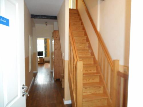 a hallway with wooden stairs in a house at Ferienhof Bisdorf "Windmühle" in Bisdorf
