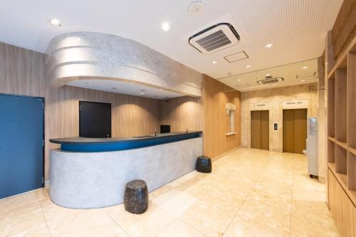 a lobby with a reception desk in a building at Urvest Hotel Kamata in Tokyo