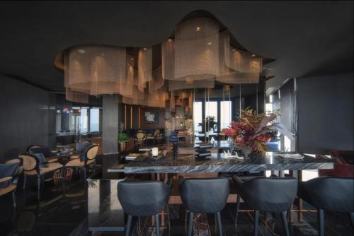 a dining room with a large table and chairs at Vacaystation Edge Central Pattaya in Pattaya Central