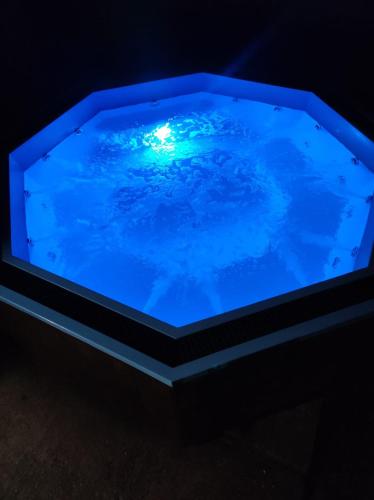 a blue tub with a light in the water at Cabana Barbu in Făgăraş