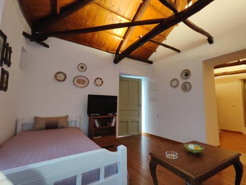 a bedroom with a bed and a table at Skopelos Mortero Cottage in Panormos Skopelos