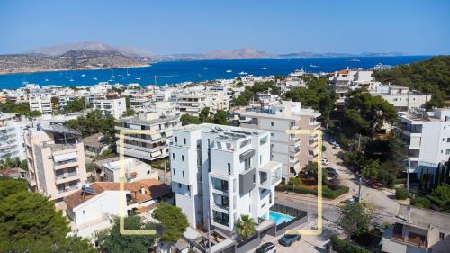 an aerial view of a city with white buildings at Emerald Stone Apartment Varkiza in Vari