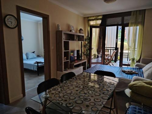 a living room with a table and a room with a couch at Санта Марина-Сладка къща in Sozopol