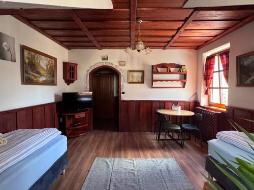 a room with two beds and a table and a table at Penzión Grand, Self Check-In, free private parking in Banská Bystrica