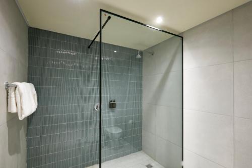 a shower with a glass door in a bathroom at Cresta Mahalapye Hotel in Mahalapye