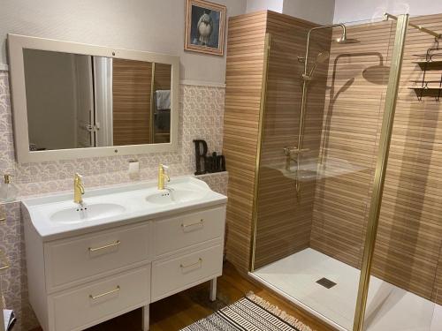 a bathroom with a sink and a shower at Villa Soleil Levant in Deauville