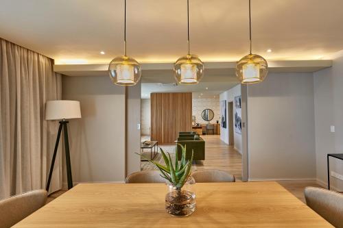 a dining room with a table and lights at Cresta Mahalapye Hotel in Mahalapye