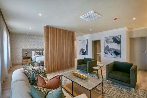 a living room with a couch and two chairs at Cresta Mahalapye Hotel in Mahalapye