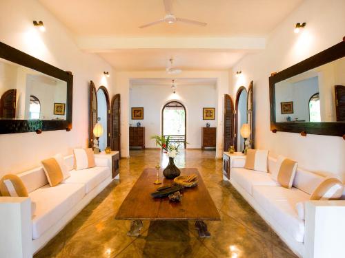 a living room with white couches and a coffee table at Villa Ocean's Edge in Ranna