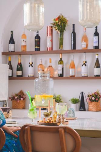 a table with a tray of drinks and wine bottles at Vila Perast Boutique Hotel in Perast