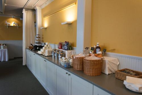 a long counter in a room with bottles and baskets at Ronnums Herrgård in Vargön