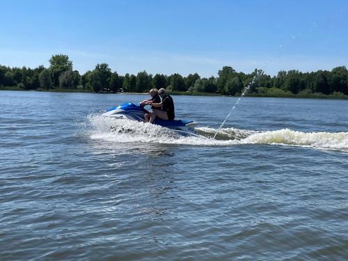 two people on a jet ski in the water at Catalpa Camp Ośrodek Rekreacyjno-Wypoczynkowy nad jeziorem Gopło in Piotrków Kujawski
