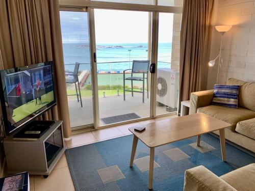 a living room with a view of the ocean at 'The Dolphins 7' - 'A View To Remember' in Port Elliot
