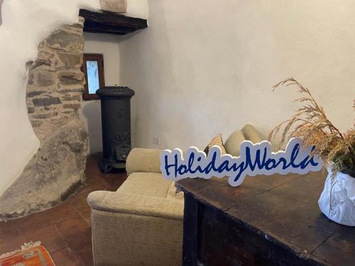 a living room with a couch and a stone fireplace at Mountains' View by Holiday World in Baiardo