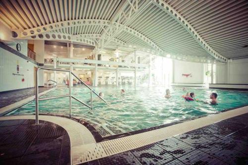a group of people swimming in a swimming pool at Driftwood Lodge - South Lakeland Leisure Village in Carnforth