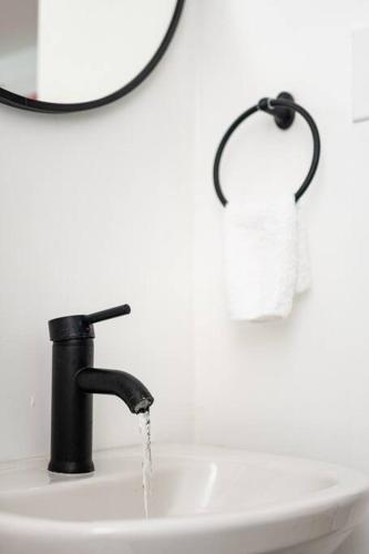 a bathroom sink with water running from a faucet at Casamares Oasis Vacacional con Piscina y Barbacoa in Cabo Rojo