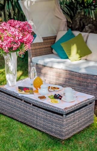 a table with a tray of food and flowers on it at Hotel Acapulco in Forte dei Marmi