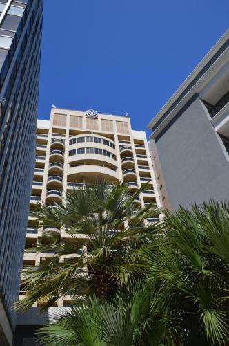 a tall building with palm trees in front of it at Gefinor Rotana &ndash; Beirut in Beirut