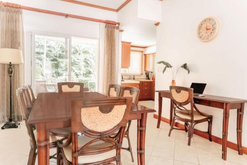 a dining room with a table and chairs at Secluded Garden Paradise Condo @Los Sueños in Herradura