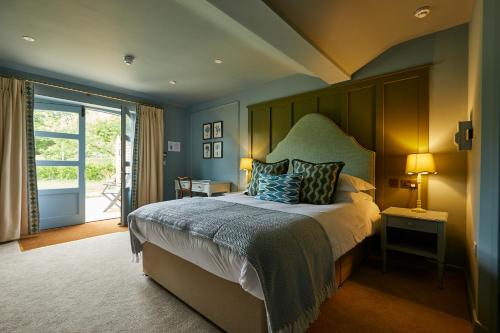 a bedroom with a large bed with a wooden headboard at The Pot Kiln in Newbury