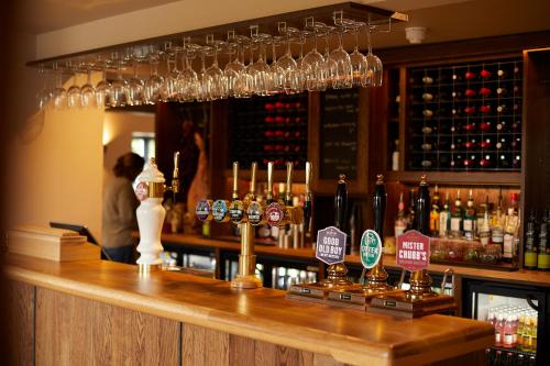 a bar with many wine glasses on top of it at The Pot Kiln in Newbury