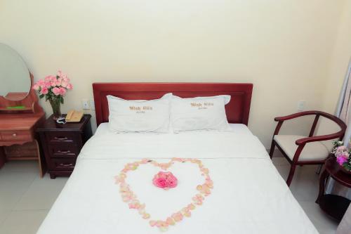 a bed with a heart made out of flowers at Minh Hiếu Hotel in Hue