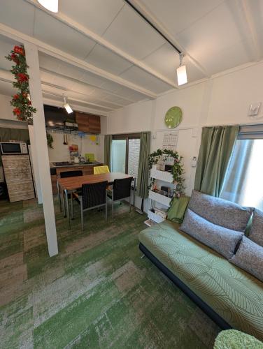 a living room with a couch and a table at UMIBE Apartment in Tokyo