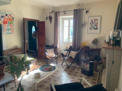 un salon avec des chaises et une table dans l'établissement BandB - les rosiers - Corse - Chambre Hellébore, à Conca