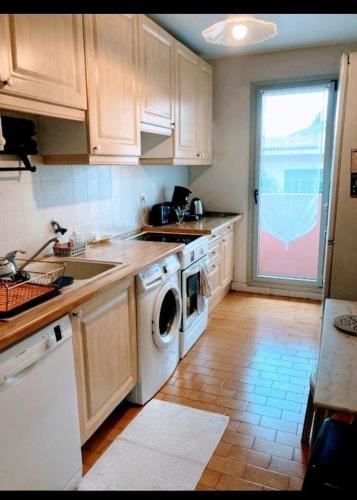 Il comprend une cuisine équipée d'un lave-linge, d'un évier et d'un lave-vaisselle. dans l'établissement Un Jardin en Ville, à Nice