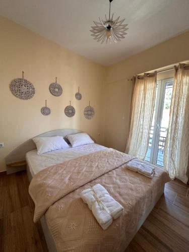 a bedroom with a large bed with towels on it at Elinor Pefkochori in Pefkohori